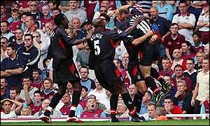 Jensen is mobbed by his team-mates after scoring Charlton's first goal