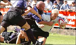 Cardiff scrum-half Ryan Powell powers his way over the tryline