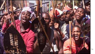 Some of 1,000 Zulu workers carrying sticks and traditional weapons march through the city centre