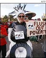 Protester dressed as a toilet holds a sign calling for delegates to 