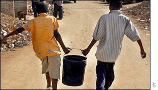 Children carrying water outside Johannesburg