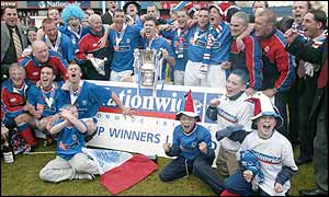 Linfield players celebrate after winning last season's Irish Cup