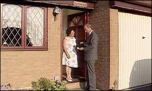 salesman at door selling to a householder