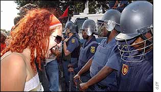 Protester faces South African police officers