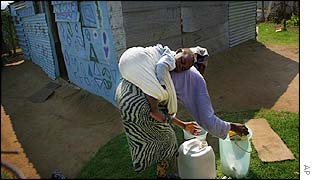 African woman washing clothes in a bucket