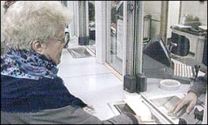 Pensioner collecting her pension from Post Office