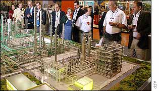 Delegates look at oil model during the congress