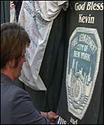 Mrs Williamson inspects items at the shrine