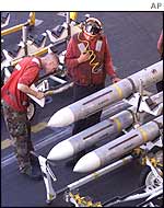 Ordnance men make ready ordnance for fighter jets on the USS George Washington aircraft carrier in the Persian Gulf