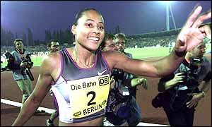 Marion Jones celebrates her win