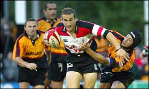 Pontypridd scrum-half Paul John is hauled back by Hal Luscombe of Newport