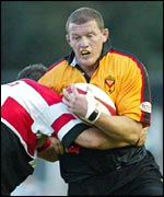 Newports Adrian Garvey is stopped by Robert Sidoli