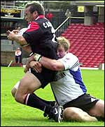 Thomas Castaignede is tackled by Bath's Mike Tindall 