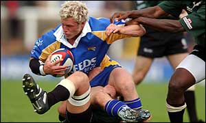 Leeds full-back Dan Scarbrough is halted by the Exiles defence