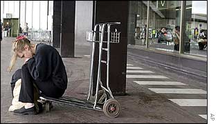A passenger waits for news at Charles de Gaulle Airport