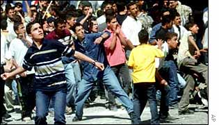Palestinian young people squaring up to Israeli forces
