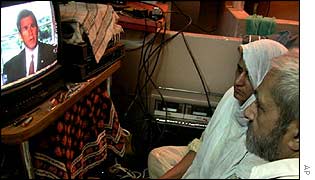 A couple watch President Bush on TV