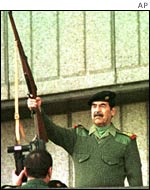 Saddam Hussein fires a rifle to mark the Grand Day of Quds in Baghdad in November 2000