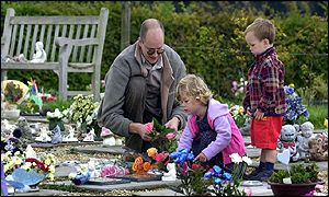 Parent Doug Turner with his children Emily and Charlie at the graves of two of his other children