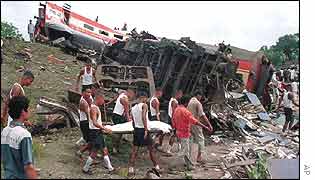 Indian soldiers carry away a body 