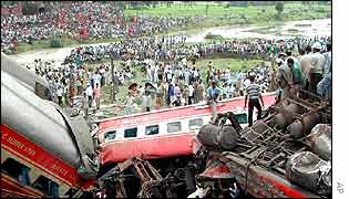 People crowd around the derailed train 