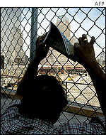 Visitors to Ground Zero of the World Trade Center in New York look at the cleared site on Tuesday.