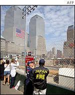 Japanese firemen from Osaka and Tokyo survey the site where the World Trade Center used to stand before it was destroyed by a terrorist attack.