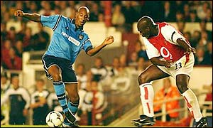 Manchester City striker Nicolas Anelka is shepherded by Arsenal's Sol Campbell