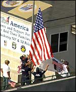 Firefighters raise US flag (AP)