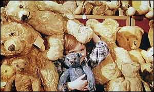 Child and some teddy bears for sale