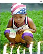 A Filipino boy, holding a gun, remembers the victims