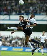 Fulham's Alain Goma challenges Teddy Sheringham of Spurs