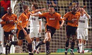 Wolves' Ludovic Pollet (centre) wheels away after making it 2-2 against Swansea