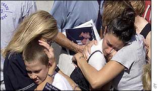 Mourners console each other at Ground Zero