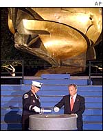 Firefighter John Vigiano and Mayor Mike Bloomberg light the eternal flame