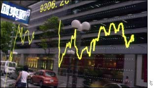 Stock graph in a window reflects a street scene