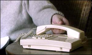 Man about to pick up telephone