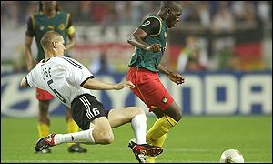 Njitap is tackled by Germany's Christian Ziege at the World Cup 