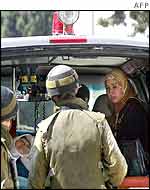 Palestinian woman is questioned by Israeli soldiers 