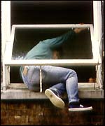 Burglar breaking into house