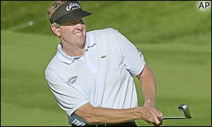 Scotland's Colin Montgomerie chips onto the green at the 13th hole