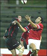 Martin Leslie (left) is outjumped by Rob Henderson