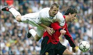 Van Nistelrooy tries to break free as Bowyer clings on for the ride