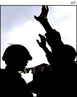 Soldier frisking civilian