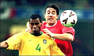Dean Saunders battles for possession with Brazil's Aldair