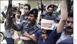Karachi police take away a suspect