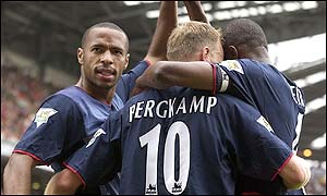 Thierry Henry is mobbed by his team-mates after putting Arsenal in front