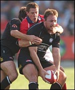 Neath No 8 Nathan Bonner-Evans holds off the challenge of Llanelli scrum-half Guy Easterby