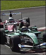 Eddie Irvine holds off Toyota's Allan McNish in the early laps at Monza
