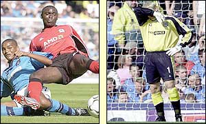 Andy Coles slides in a goal past Man City goalkeeper Peter Schmeichel